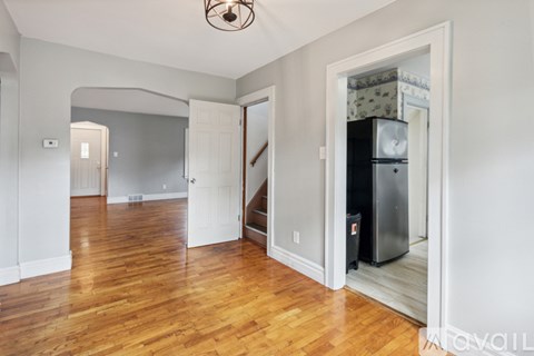 A kitchen area with a refrigerator and a stove top oven.