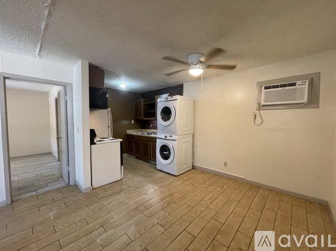 A room with a washer and dryer in it.
