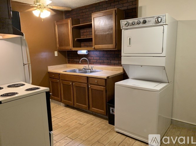 A kitchen with a white stove and a white oven.