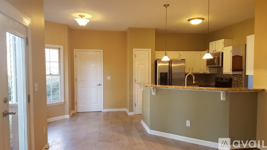 A kitchen with a counter and cabinets is available for rent.