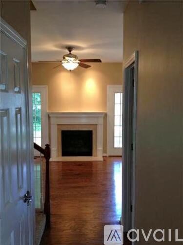 A room with a fireplace and a ceiling fan.