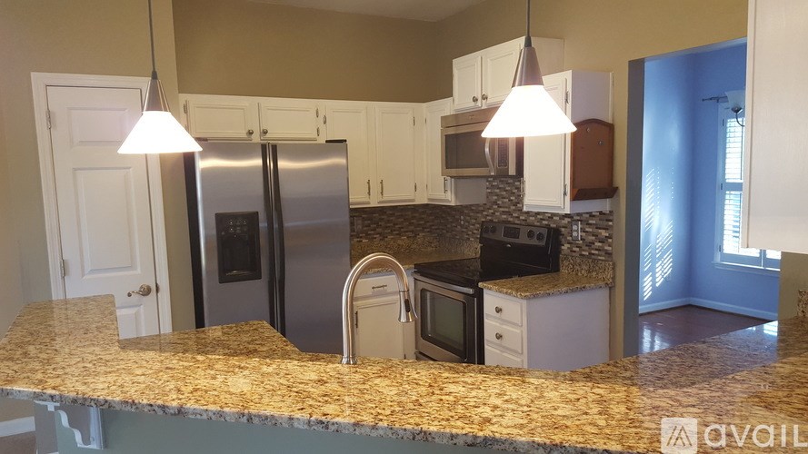 A kitchen with granite countertops and stainless steel appliances.