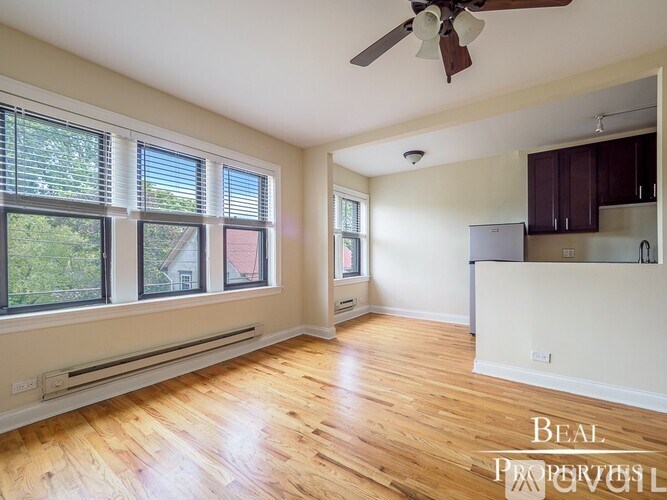A room with wooden floors and a ceiling fan.