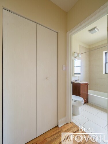 A white bathroom with a toilet and a shower.