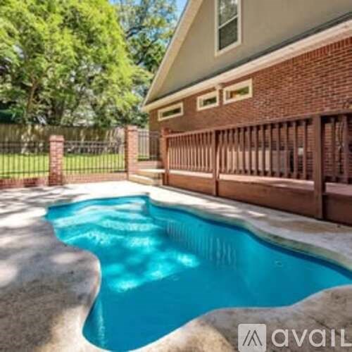 A small pool in front of a house.