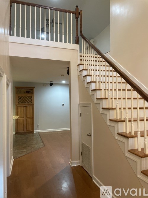 A staircase with a white railing and wooden steps.
