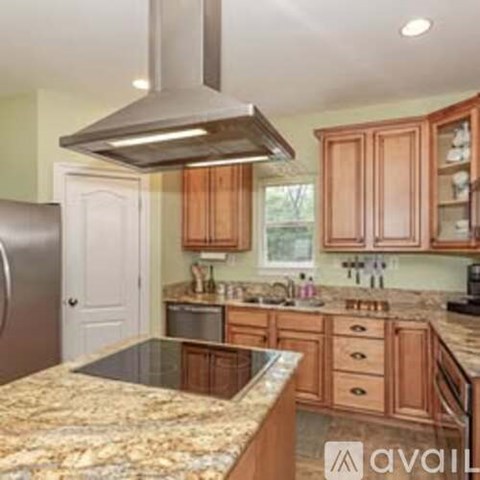 A kitchen with wooden cabinets and granite countertops.