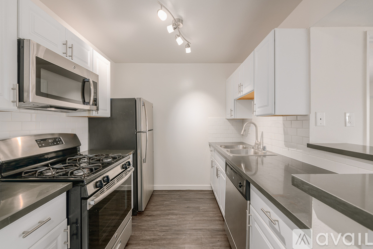 A kitchen with white cabinets and stainless steel appliances.