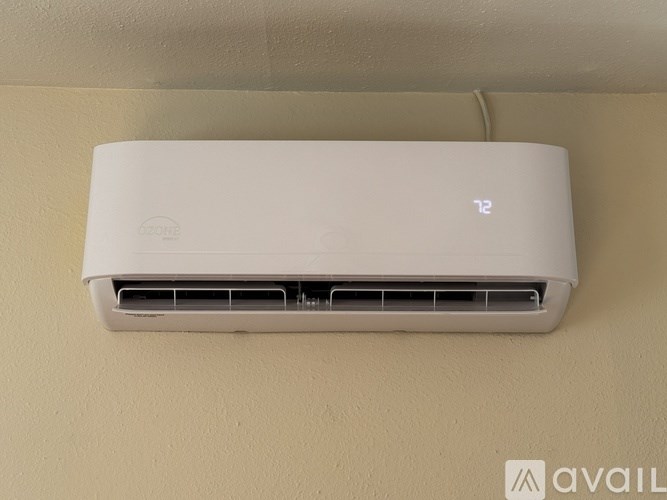 A white air conditioner unit is mounted on a wall.