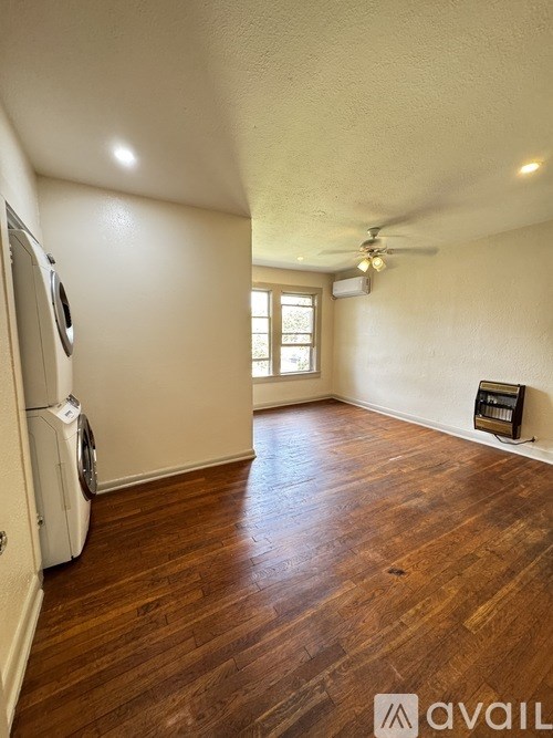 A room with wooden floors and a window.