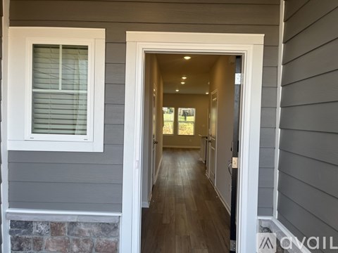 A hallway with a doorway leading to another room.