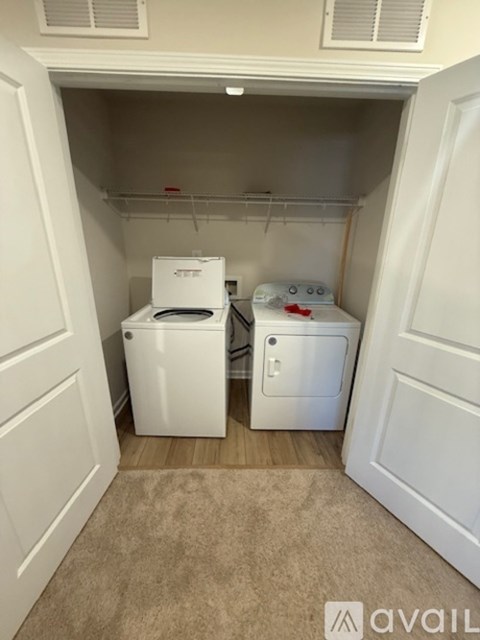 A small laundry room with a washer and dryer.