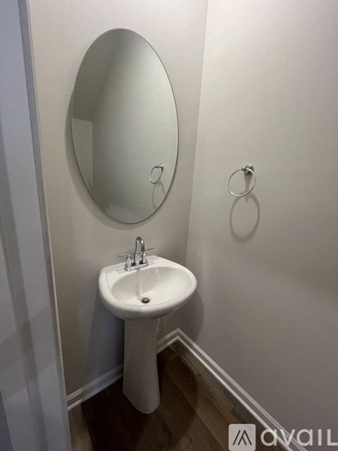 A white sink in a small bathroom.