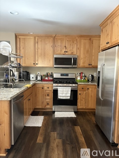A kitchen with wooden cabinets and stainless steel appliances.