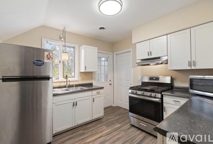 A kitchen with a stainless steel refrigerator and a stainless steel oven.
