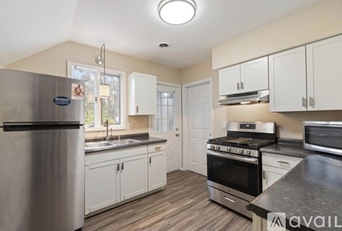 A kitchen with a stainless steel refrigerator and a stainless steel oven.