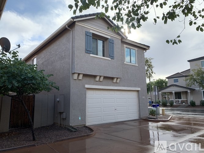 A house with a grey exterior and a white garage door.