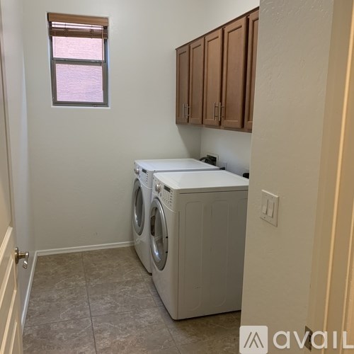A small laundry room with a washer and dryer.