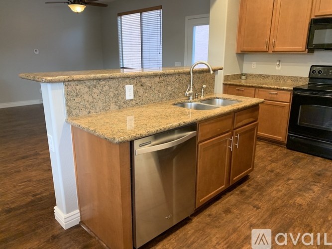 A kitchen with granite countertops and stainless steel appliances.