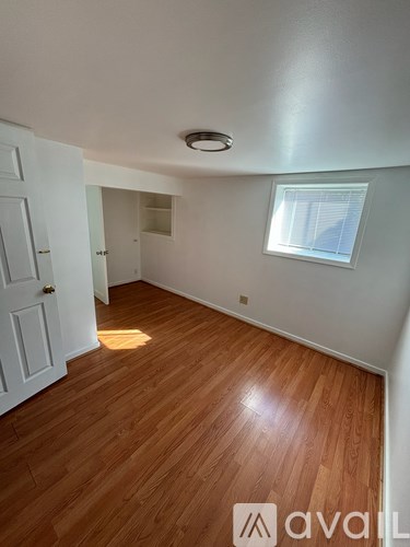 A room with wooden floors and a window.