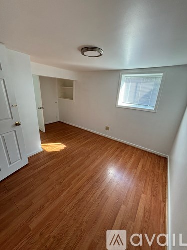 A room with wooden floors and white walls.