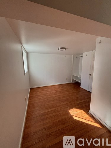 A room with wooden floors and white walls.