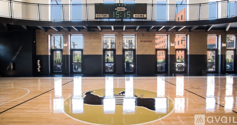 A basketball court with a scoreboard showing 15-14 in favor of the home team.