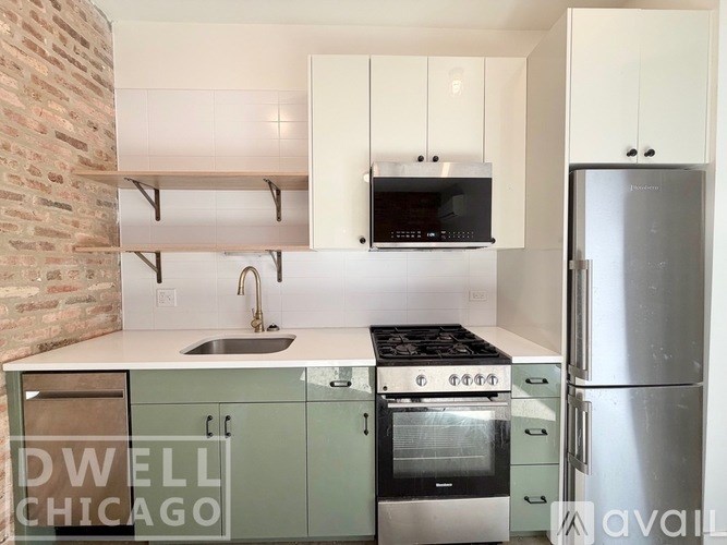 A kitchen with a brick wall and a stove top oven.