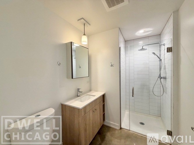 A modern bathroom with a walk-in shower and a sink vanity.