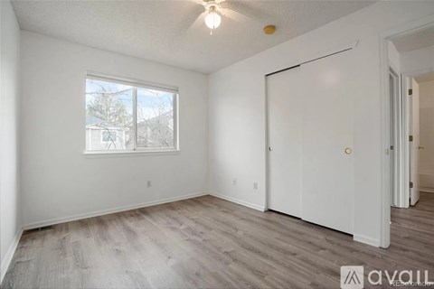 A room with a window and a door is available for rent.