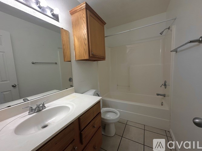 A bathroom with a sink, toilet, and bathtub.