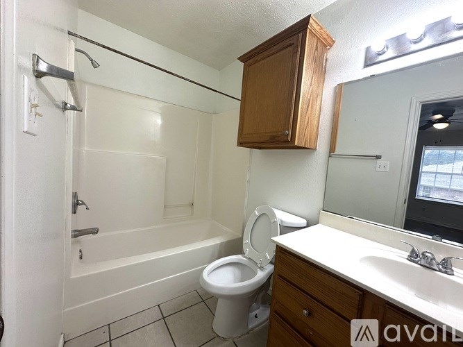 A bathroom with a toilet, sink, and bathtub.