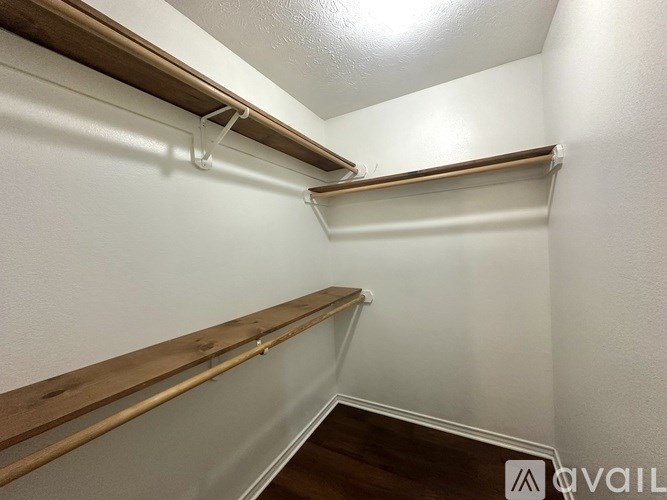 A white wall with a wooden shelf on top.