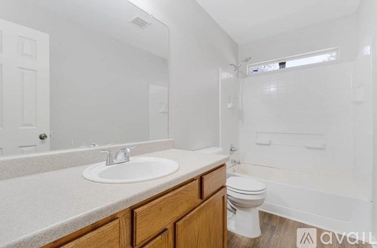 A white bathroom with a sink, toilet, and bathtub.