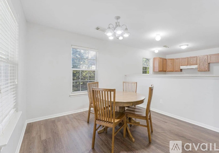 A dining room with a table and chairs.