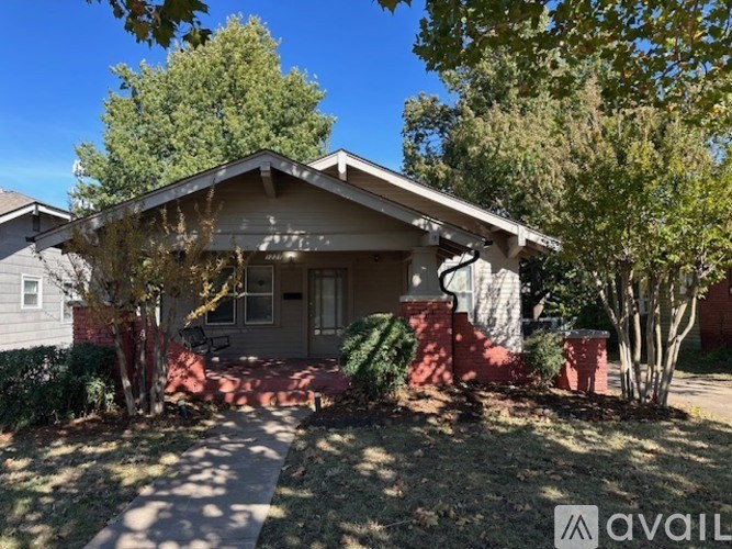 A house with a front yard and trees.