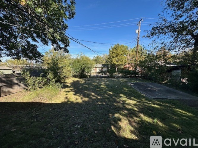 A sunny day in a residential area with houses and trees.