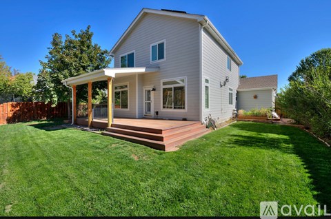 A house with a white exterior and a covered patio area.