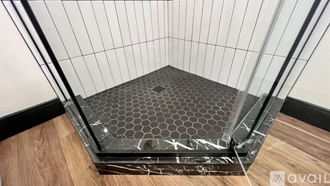 A glass table with a hexagonal tile top and a wooden floor.