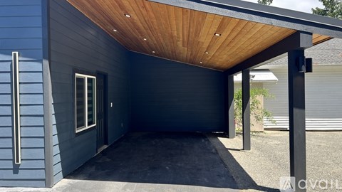 A modern house with a wooden roof and a covered entrance.