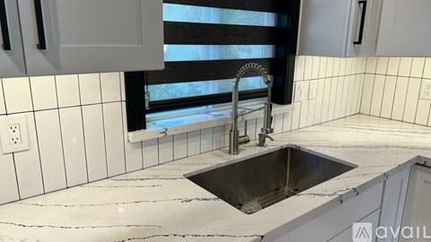 A kitchen with a sink and a window.