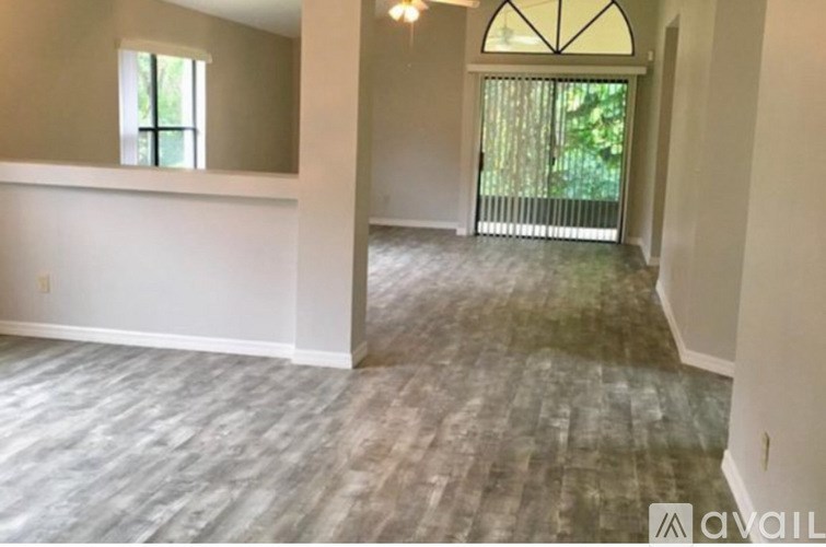 A room with a window and a door leading outside.