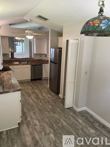 A kitchen with a refrigerator, stove, and oven.