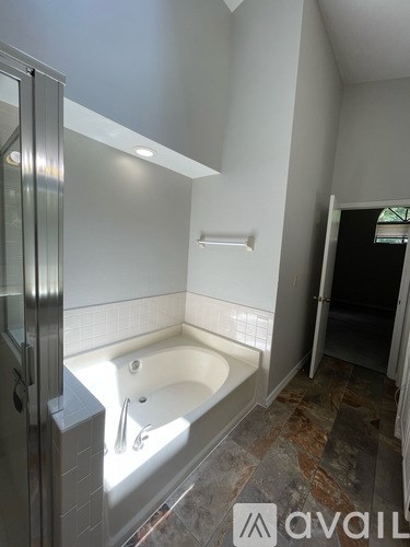 A bathroom with a tub and a walk-in shower.