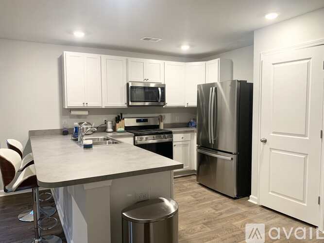 A kitchen with white cabinets and stainless steel appliances.