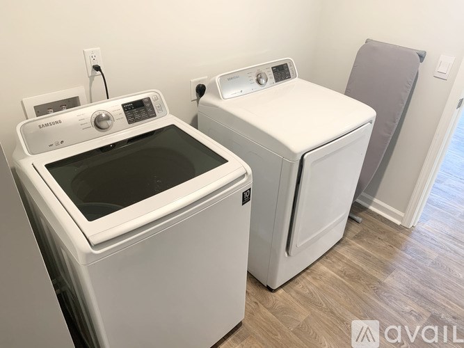 A white dryer and washer are available for use.