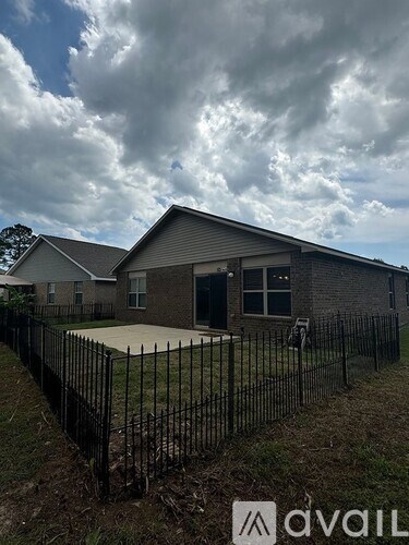 A house with a black fence in front of it.