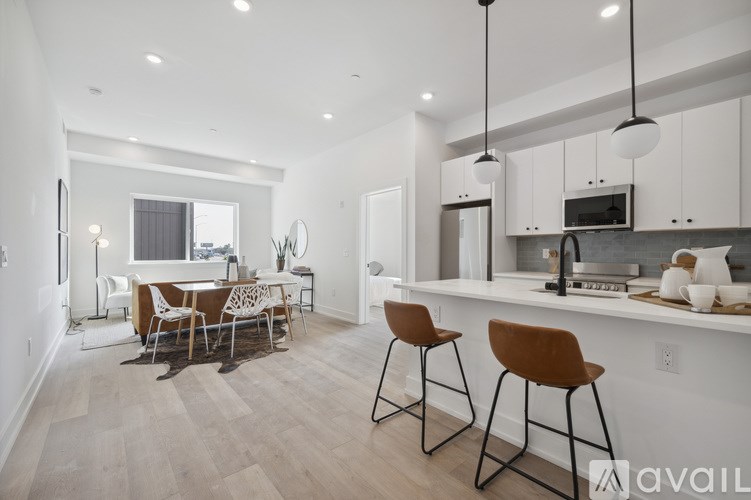 A modern kitchen with a dining table and chairs.