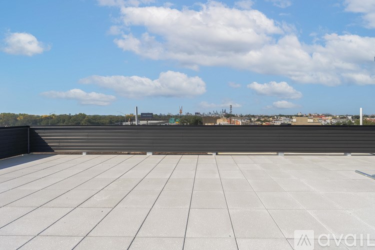 A rooftop with a view of the cityscape and sky.