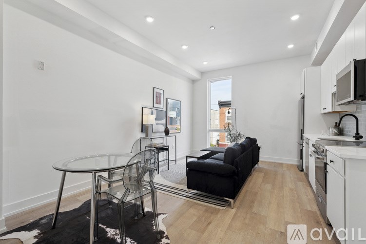 A modern kitchen with a glass table and chairs.